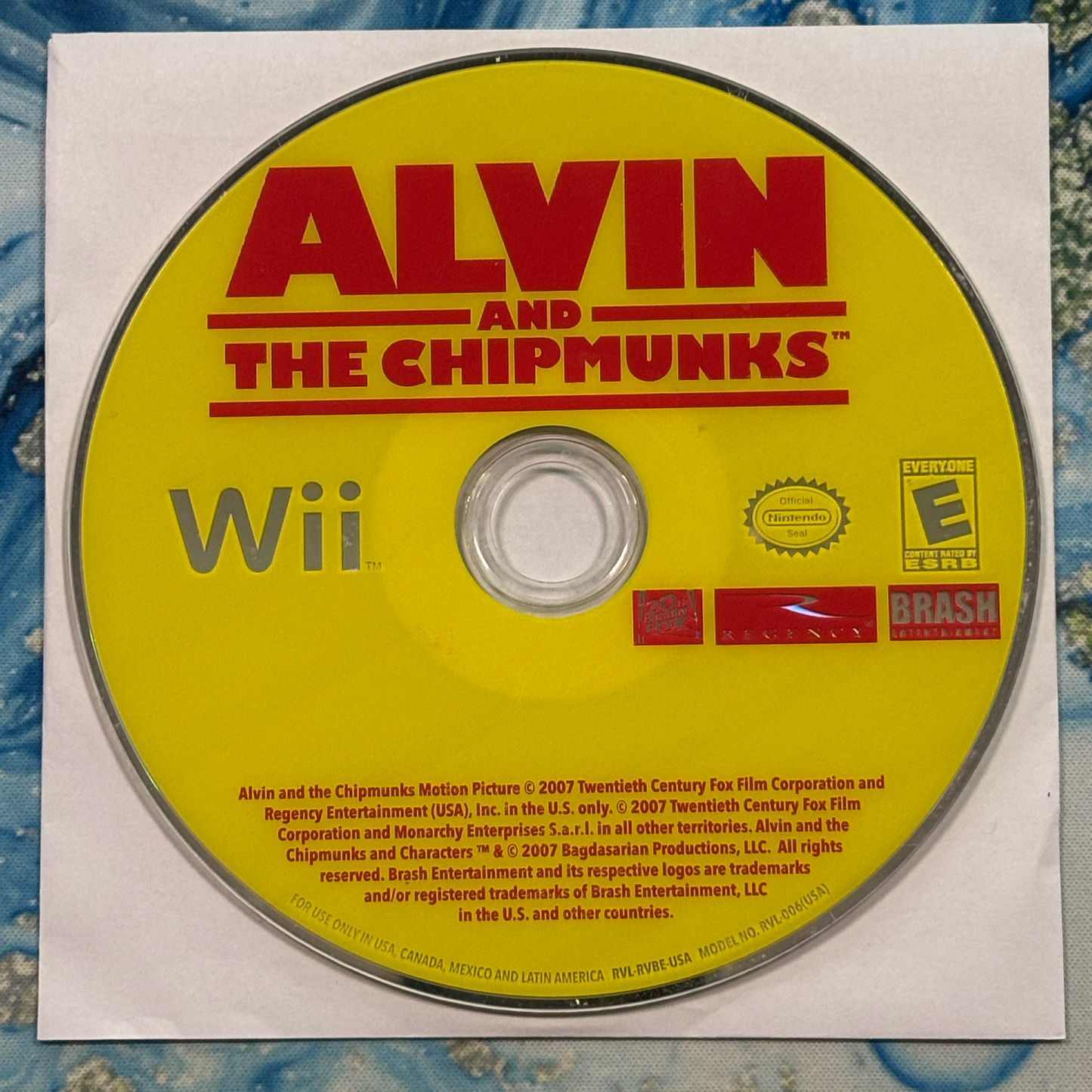 Wii game disc for 'Alvin and the Chipmunks' on a textured surface