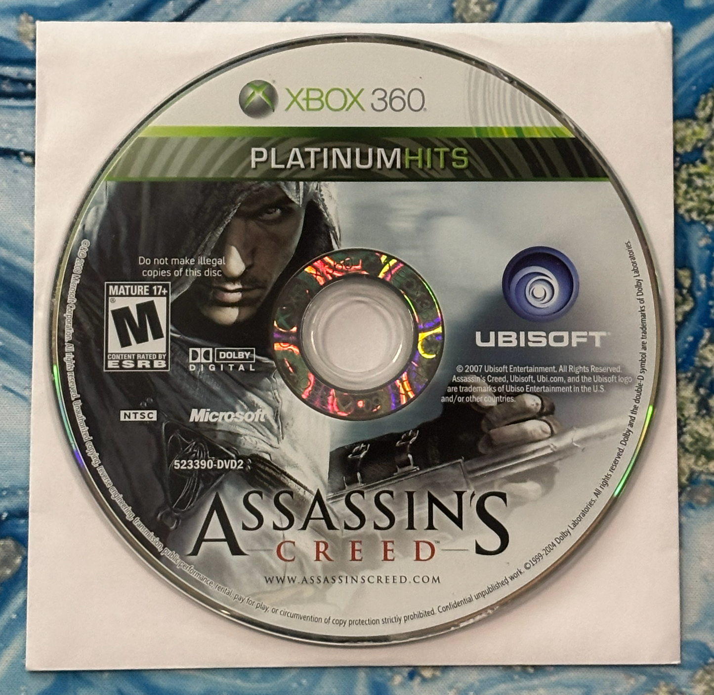Assassin's Creed game disc for Xbox 360 on a white background