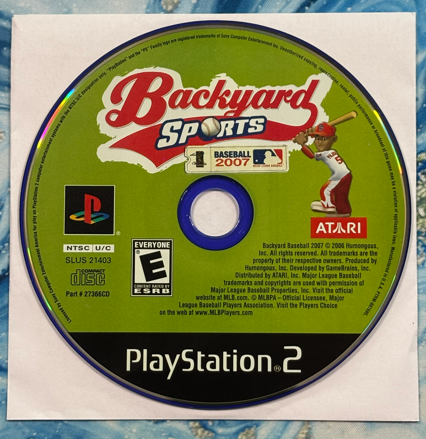 Backyard Sports Baseball 2007 game disc for PlayStation 2 on a textured surface
