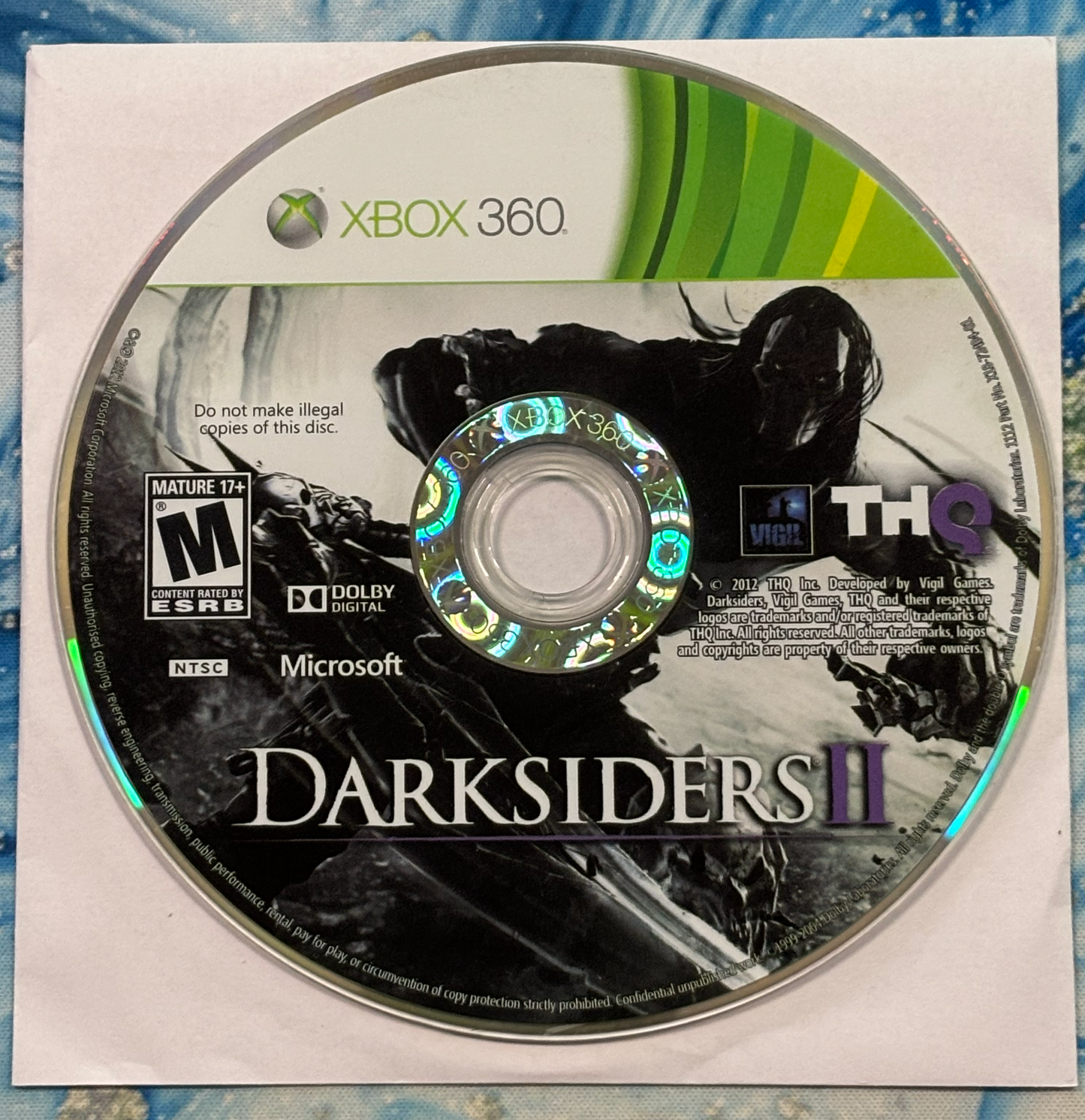Game disc for 'Darksiders II' on Xbox 360 with THQ logo