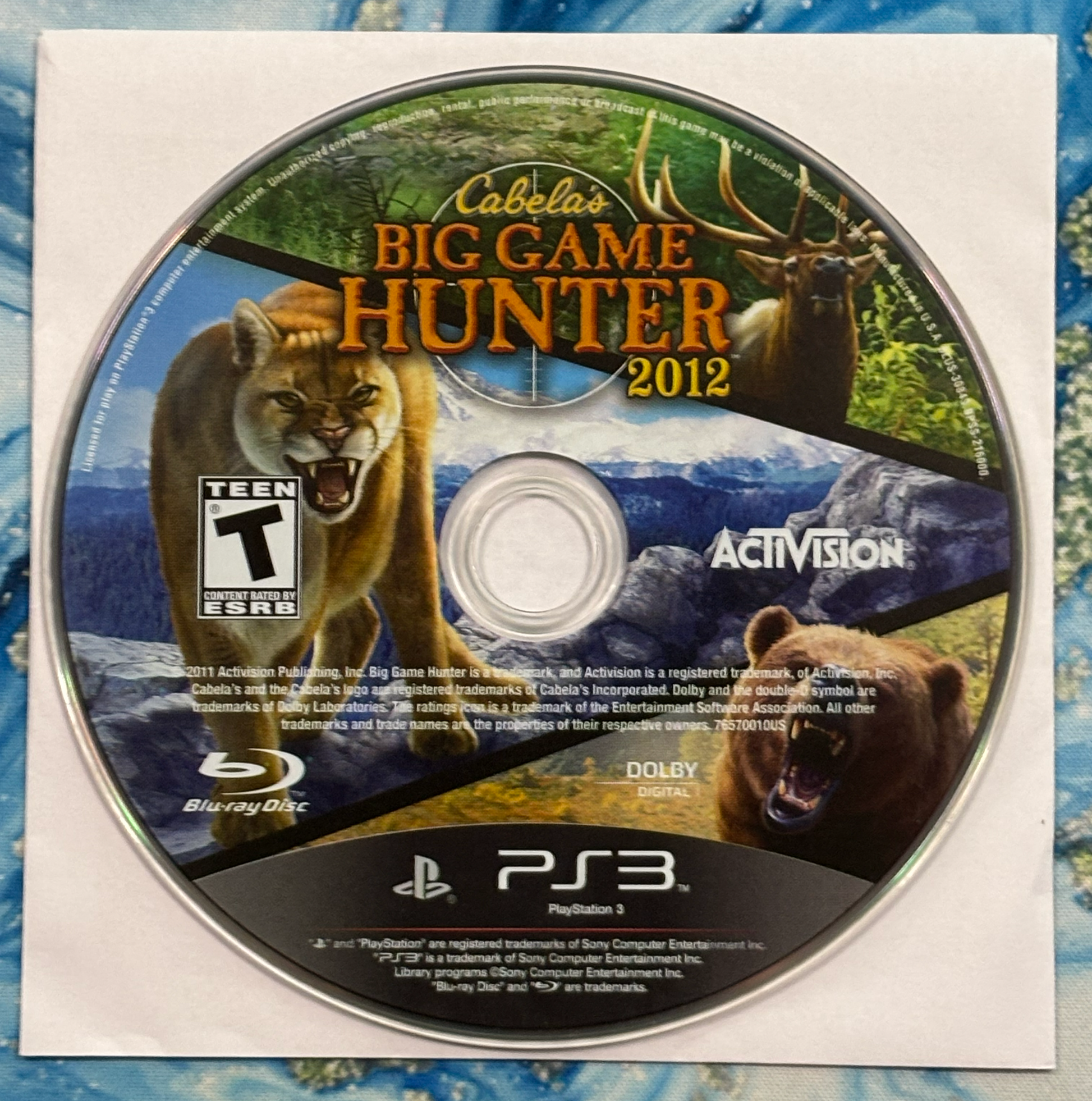 Cabela's Big Game Hunter 2012 game disc with cover on a textured surface