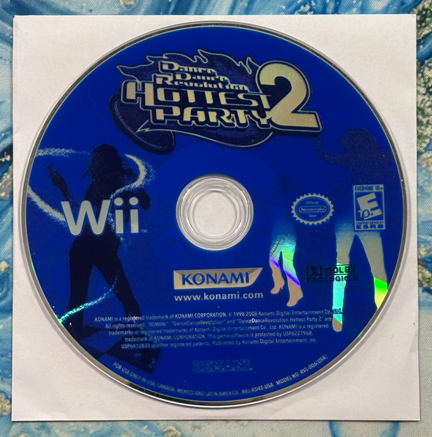 Game disc for 'Dance Dance Revolution Hottest Party 2' on a Wii console with Konami branding.