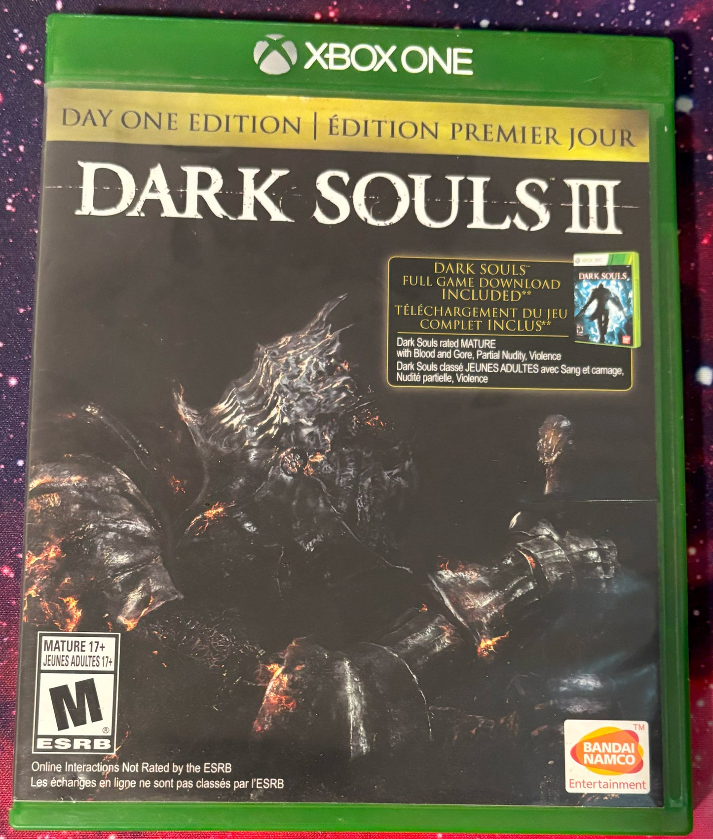 Game case for 'Dark Souls III' Day One Edition on Xbox One with green border and character artwork.