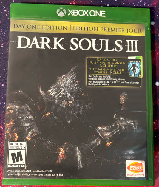 Game case for 'Dark Souls III' Day One Edition on Xbox One with green border and character artwork.
