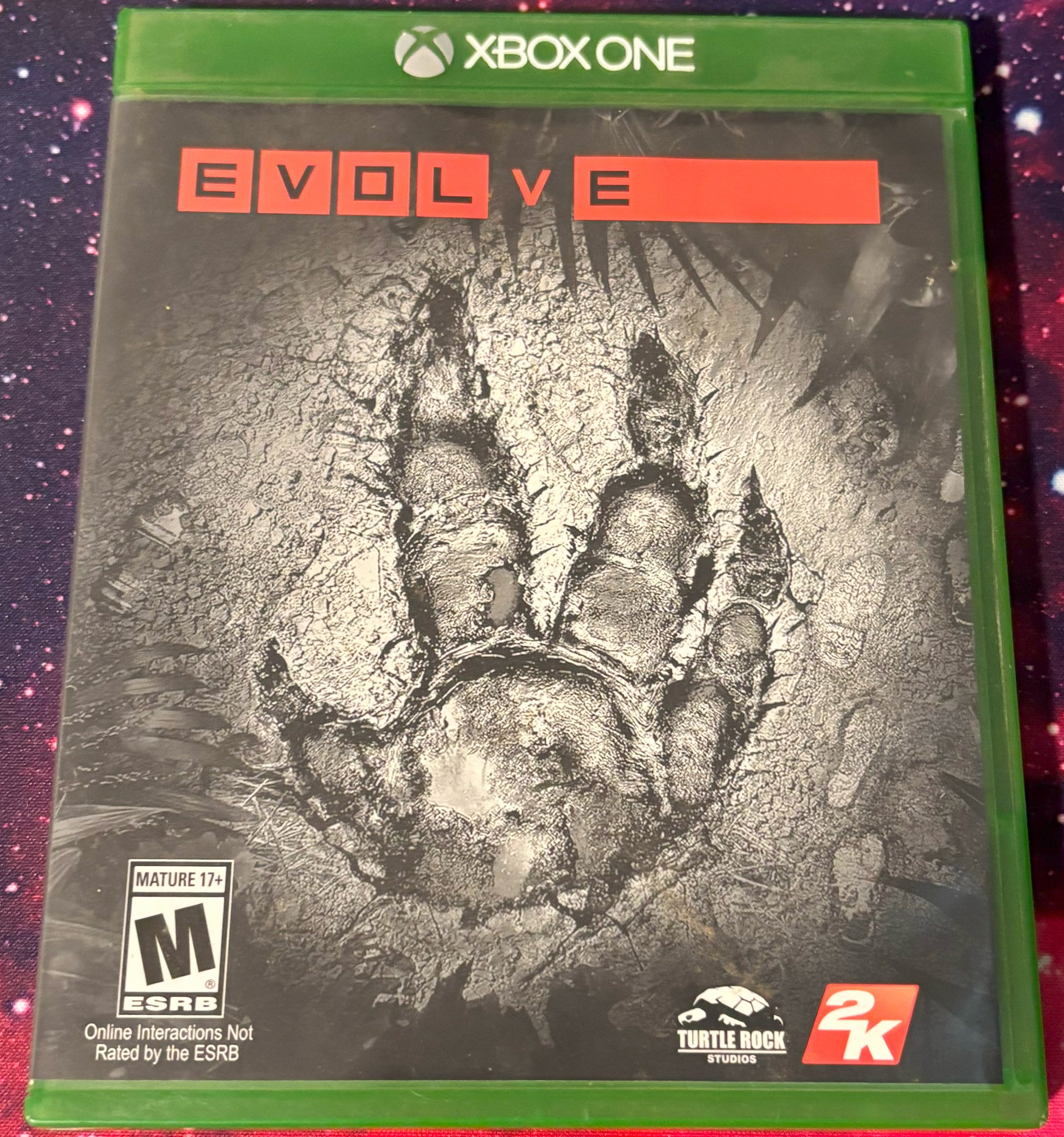 Game case for 'Evolve' on Xbox One with a dinosaur footprint design.