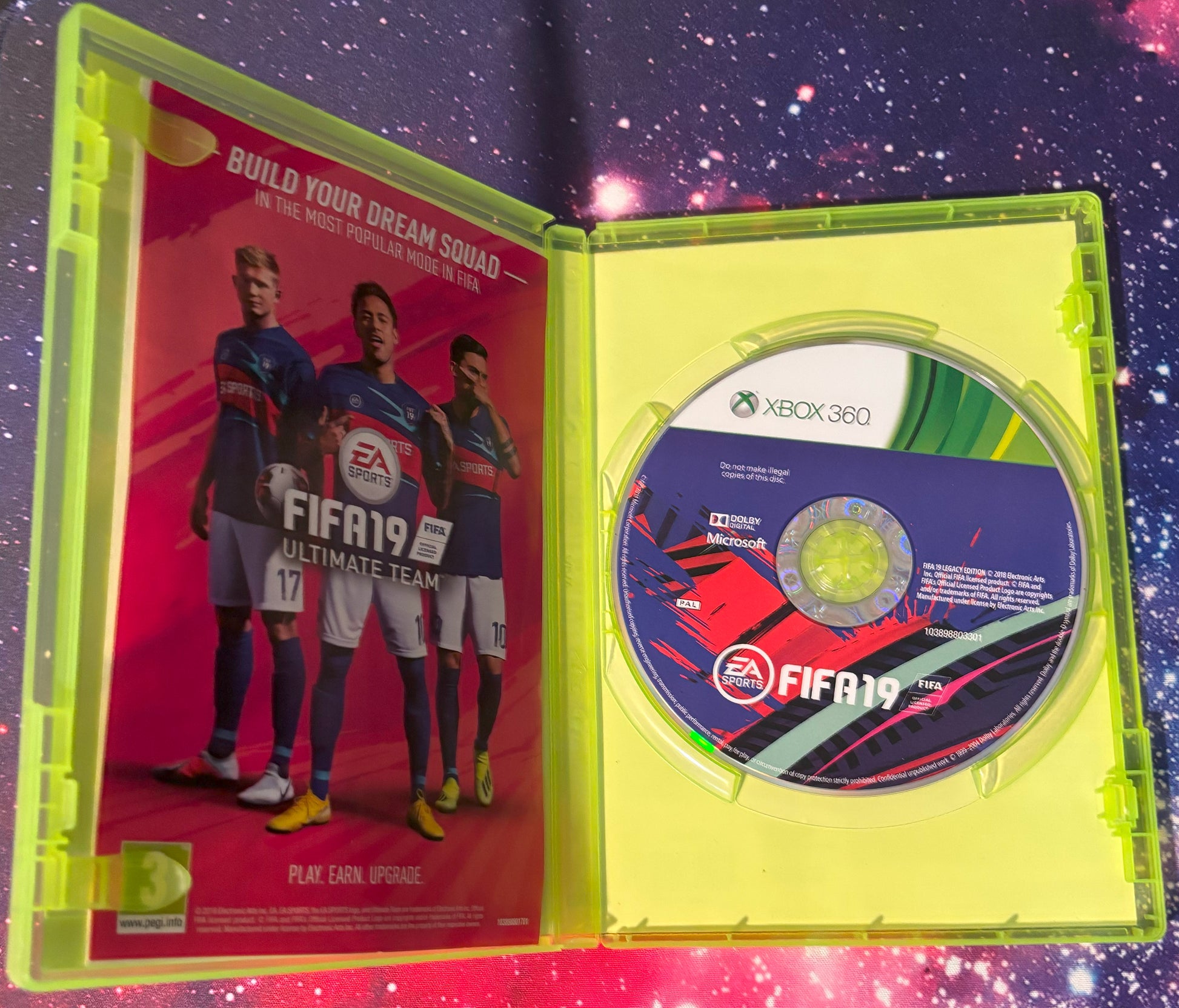 Xbox 360 game disc in FIFA 19 packaging with EA Sports branding on a colorful background