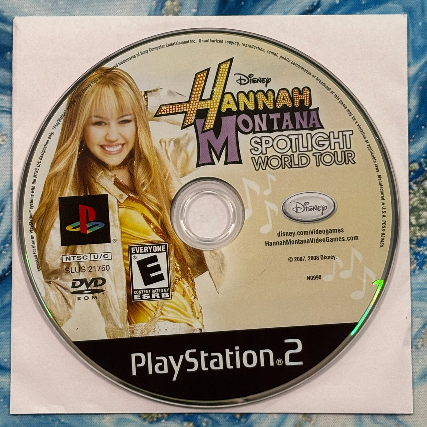 Hannah Montana PlayStation 2 game disc on a textured surface