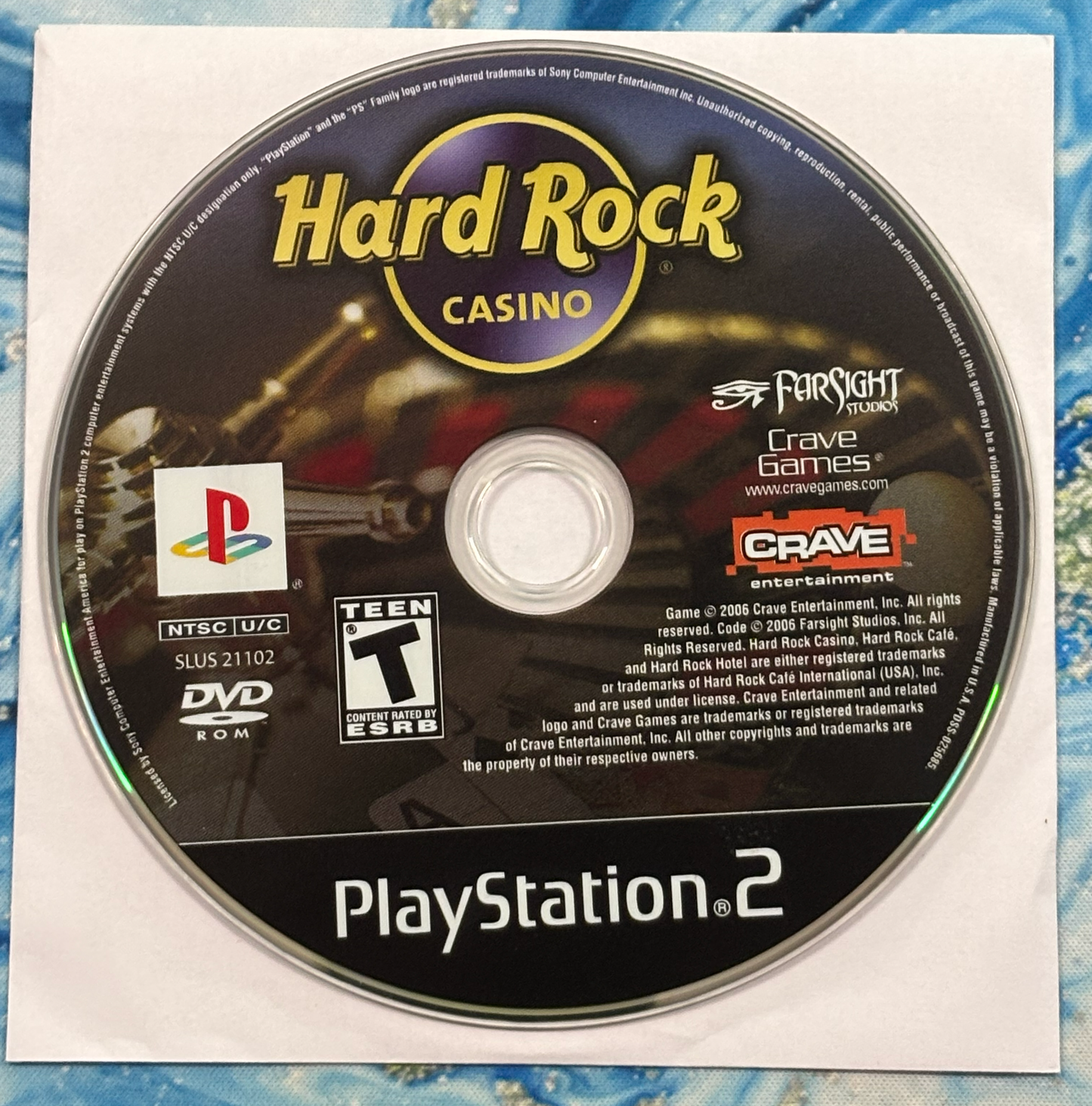 PlayStation 2 game disc for 'Hard Rock Casino' on a textured surface
