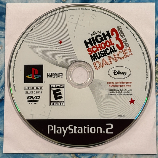PlayStation 2 game disc for 'High School Musical 3: Senior Year Dance' on a textured surface.