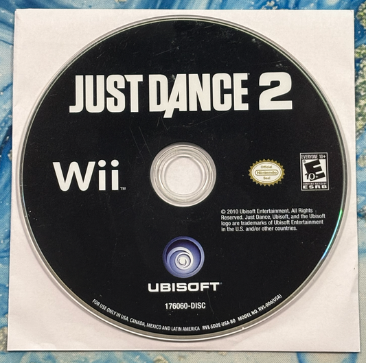 Just Dance 2 Wii game disc on a textured surface