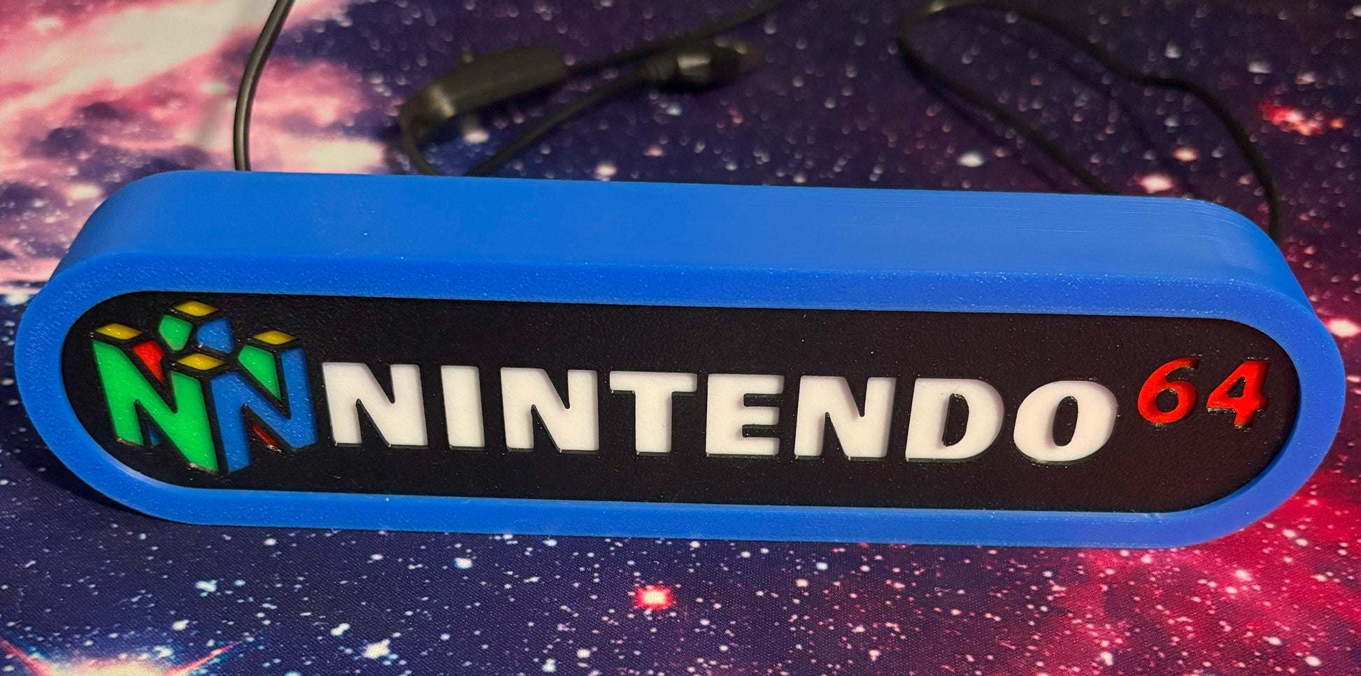Nintendo 64 logo on a blue background with a space-themed wallpaper.