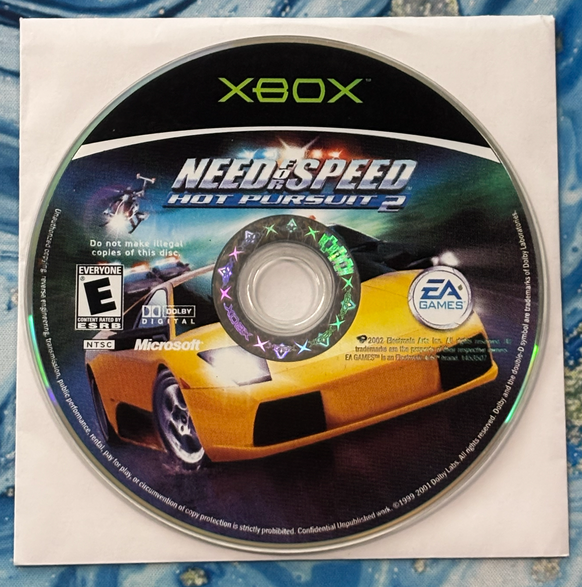 Xbox game disc for 'Need for Speed: Hot Pursuit 2' on a white background