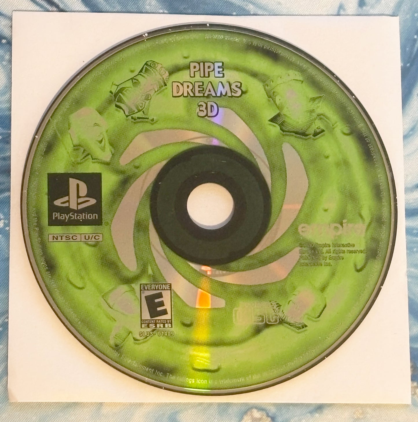 Green PlayStation game disc labeled 'Pipe Dreams 3D' on a white background