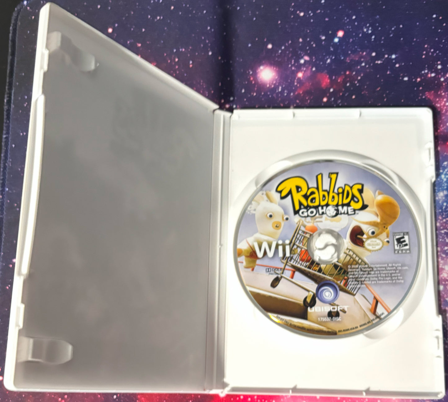 Game disc for 'Rabbids Go Home' on a Wii console with a space-themed background