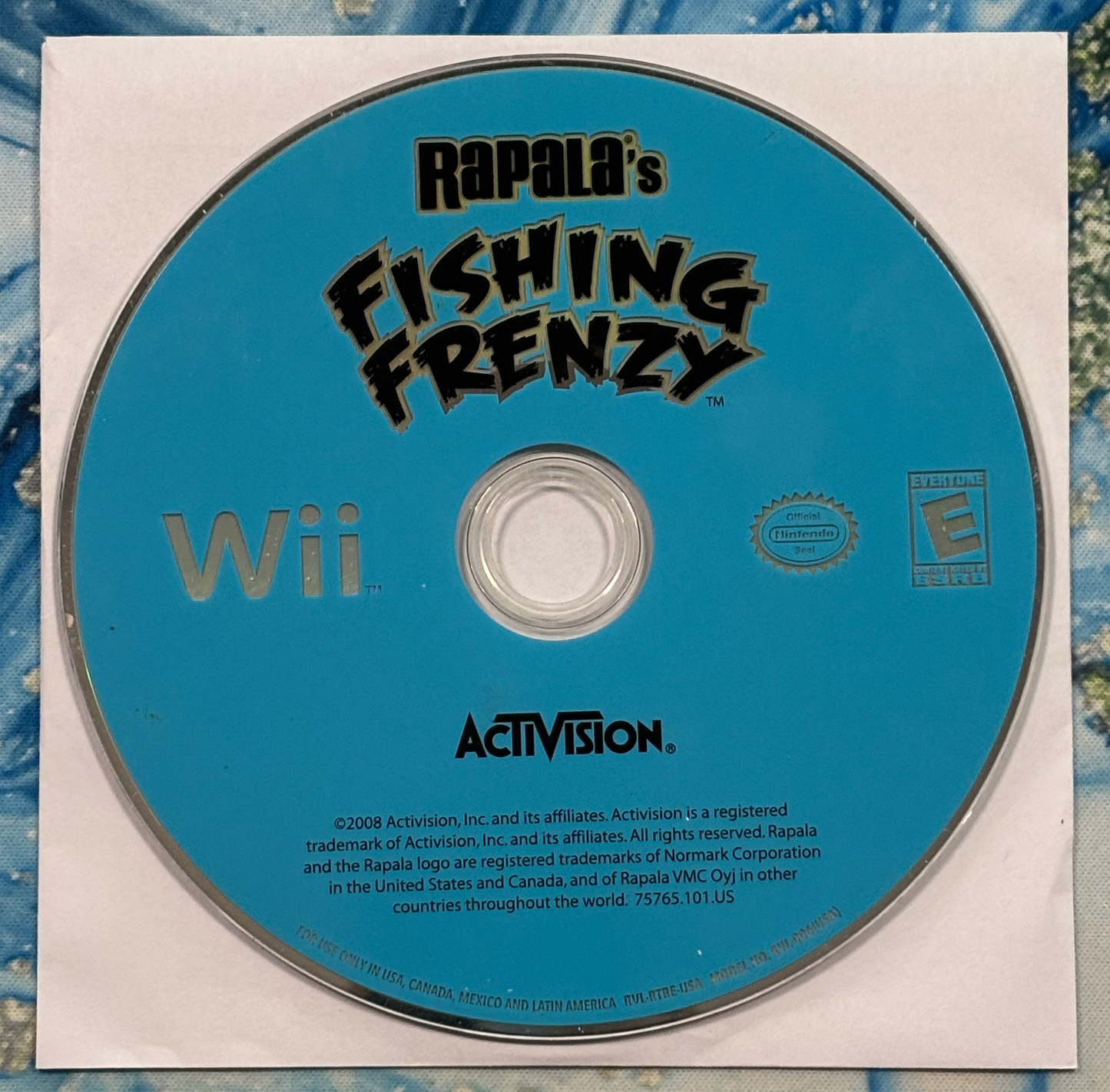 Rapala's Fishing Frenzy Wii game disc with Activision branding on a textured surface