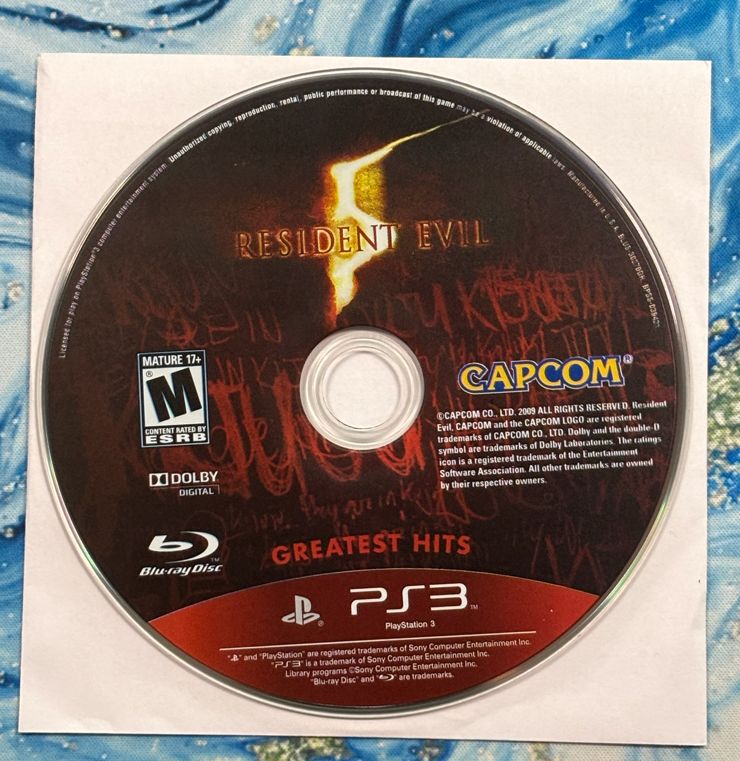 Resident Evil game disc on a PlayStation 3 branded case with Capcom logo