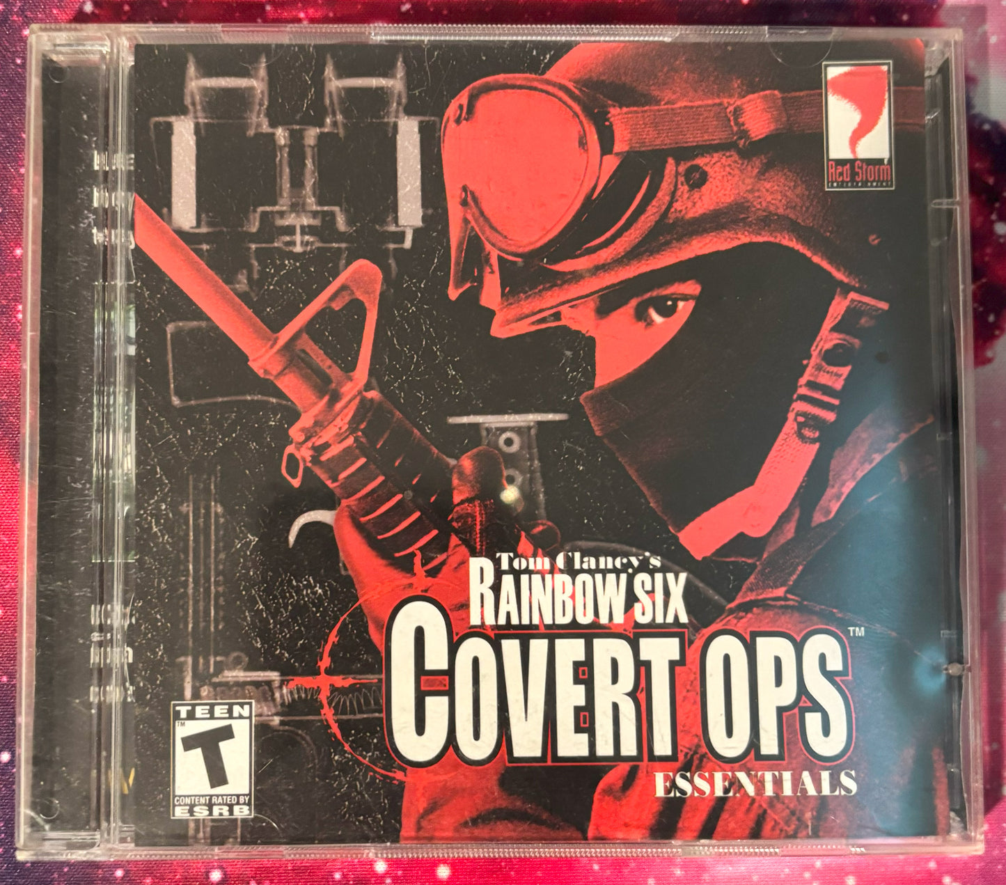 Game case for 'Tom Clancy's Rainbow Six Covert Ops Essentials' with a red and black design.