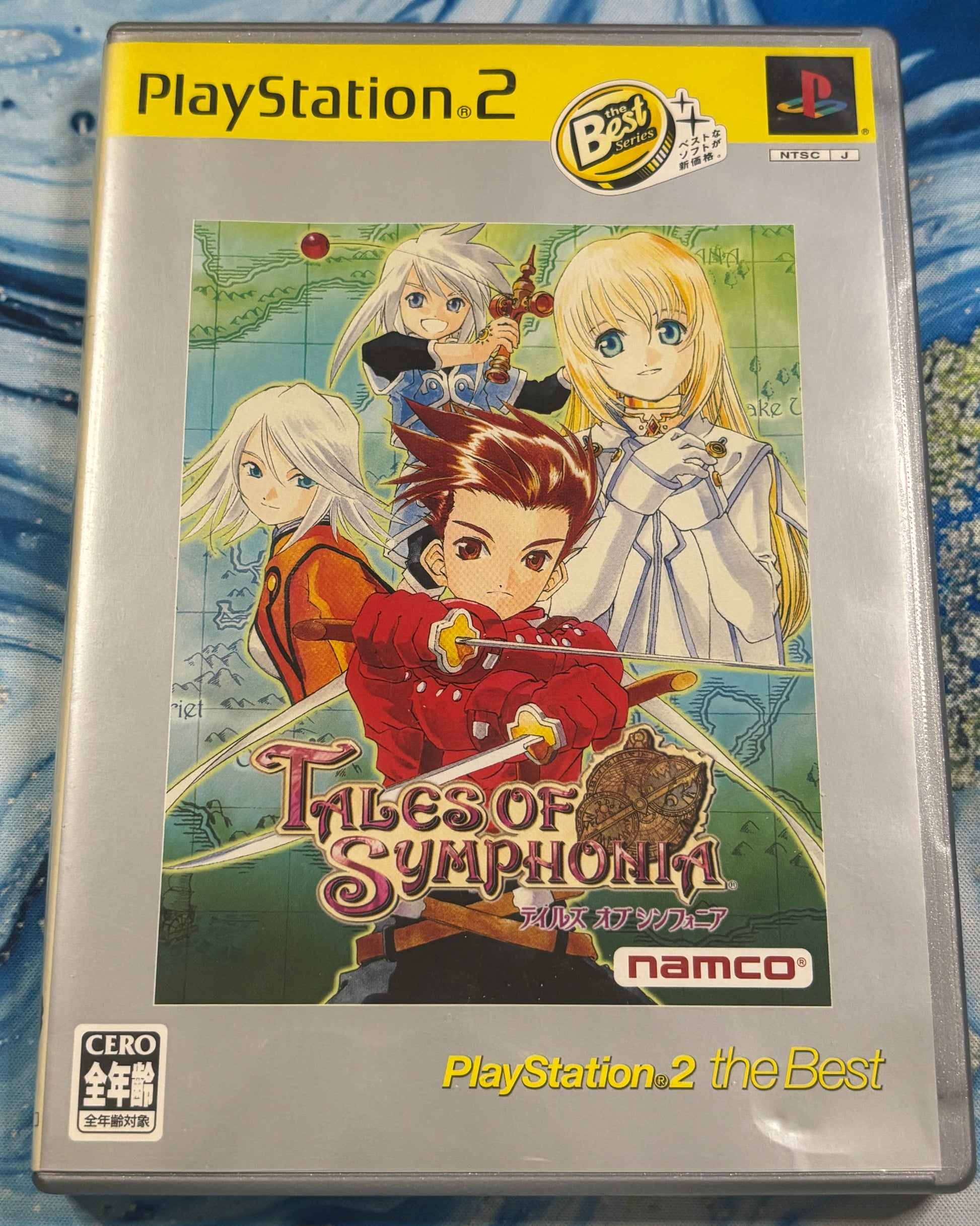 Tales of Symphonia for Xbox 365 / PlayStation 2 game case, featuring anime characters from the game on the front cover, with PlayStation 2 branding and Namco logos visible.