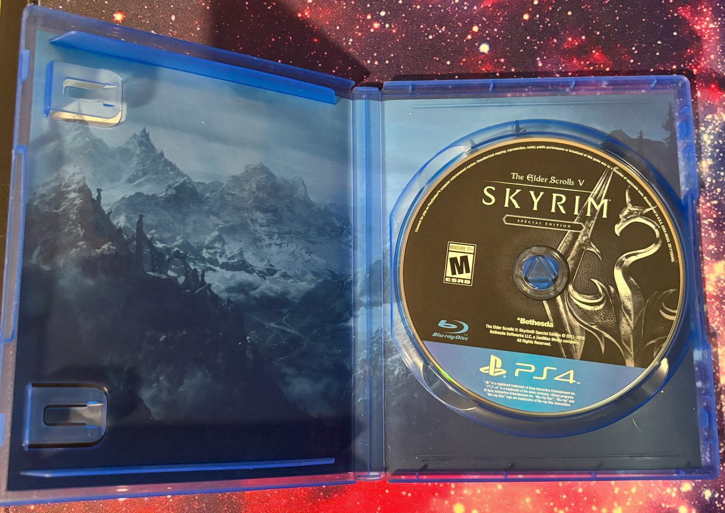 PlayStation 4 game disc in 'Skyrim' case with mountain graphic
