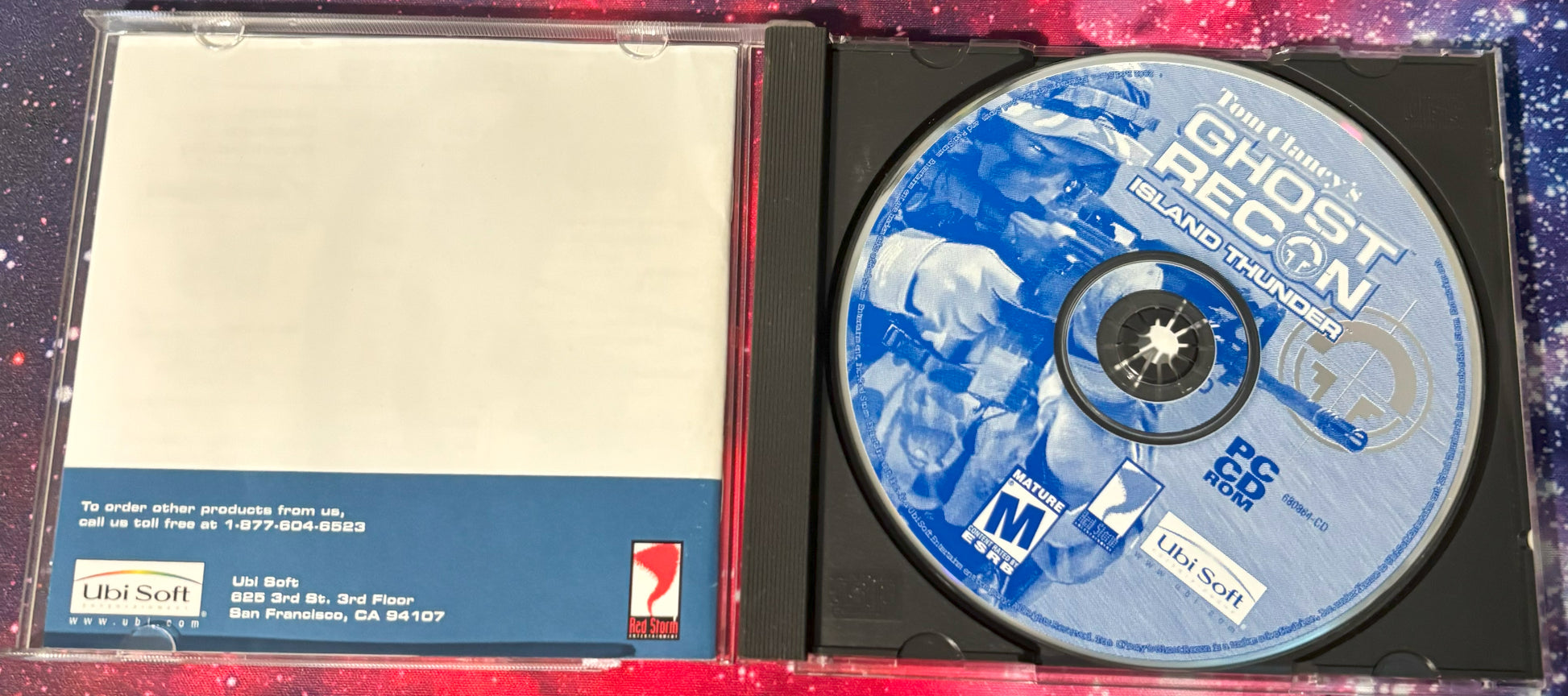 CD with 'Ghost Recon' branding inside a case on a colorful background