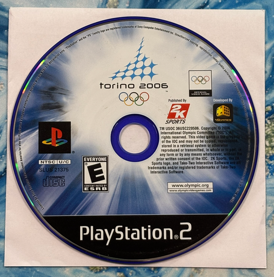 PlayStation 2 game disc for 'Torino 2006' Olympics on a textured surface