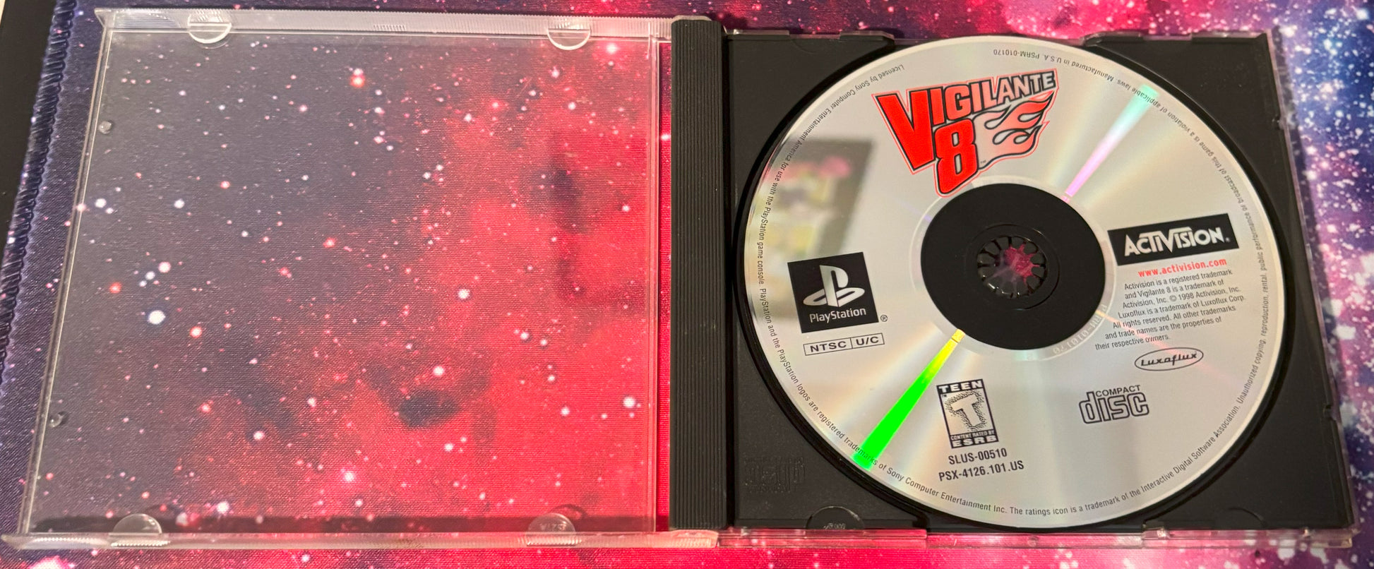PlayStation game disc in a case with 'Vigilante 8' branding on a colorful background